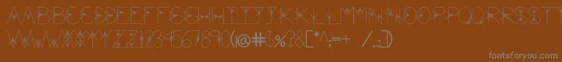 TheValley-fontti – harmaat kirjasimet ruskealla taustalla