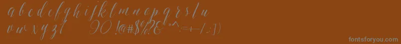SheilovaScript-Schriftart – Graue Schriften auf braunem Hintergrund