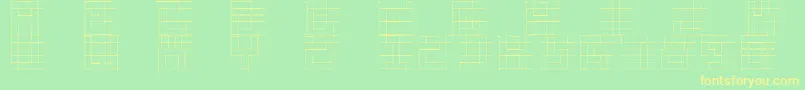 フォントSketchiquac – 黄色の文字が緑の背景にあります