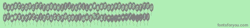 Fonte SfBalloonsThinItalic – fontes cinzas em um fundo verde