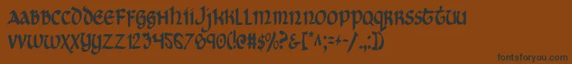 フォントCryUncialCondensed – 黒い文字が茶色の背景にあります