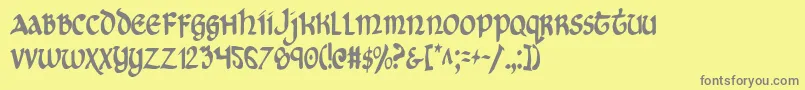 フォントCryUncialCondensed – 黄色の背景に灰色の文字