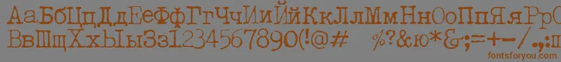 フォントLetteratrentadueTranslit – 茶色の文字が灰色の背景にあります。
