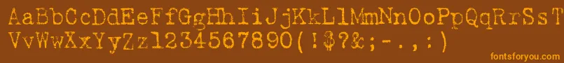 フォント9fukolym – オレンジ色の文字が茶色の背景にあります。