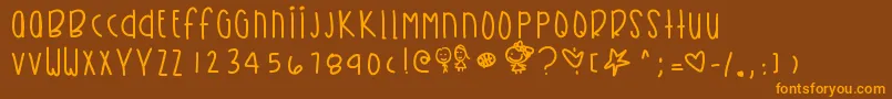 Kirbysdreamland-Schriftart – Orangefarbene Schriften auf braunem Hintergrund