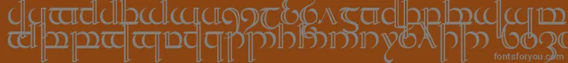 Quencap2-fontti – harmaat kirjasimet ruskealla taustalla