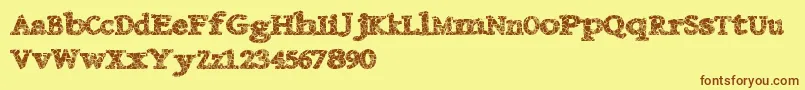 フォントDanishcrack – 茶色の文字が黄色の背景にあります。