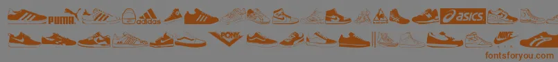 フォントSneakers – 茶色の文字が灰色の背景にあります。