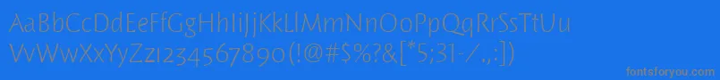 WoodlandltitcTt-Schriftart – Graue Schriften auf blauem Hintergrund