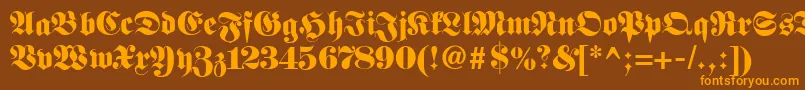 フォントFetteclassicunzfraktur – オレンジ色の文字が茶色の背景にあります。