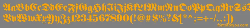 フォントFetteclassicunzfraktur – オレンジの文字は灰色の背景にあります。