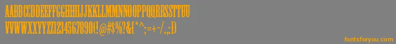フォントMesquitestd – オレンジの文字は灰色の背景にあります。