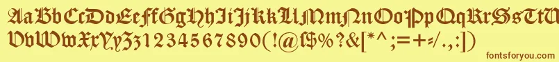 フォントDscaslongotisch – 茶色の文字が黄色の背景にあります。