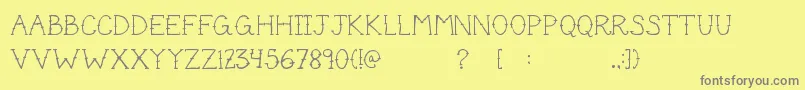CuteTattoo-fontti – harmaat kirjasimet keltaisella taustalla