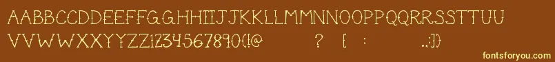 CuteTattoo-fontti – keltaiset fontit ruskealla taustalla