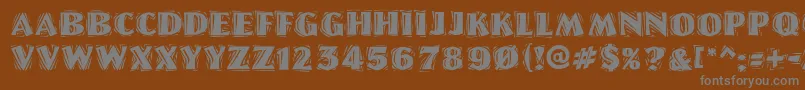 LinoletterCutRaggedRegular-fontti – harmaat kirjasimet ruskealla taustalla