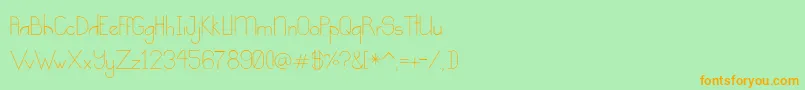 フォントKindness – オレンジの文字が緑の背景にあります。