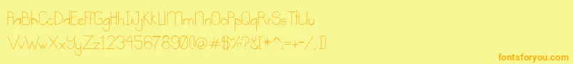 フォントKindness – オレンジの文字が黄色の背景にあります。