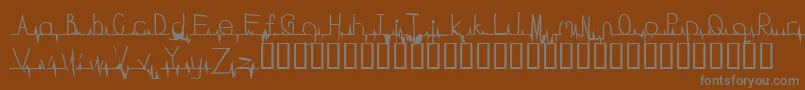 フォントFlatline – 茶色の背景に灰色の文字