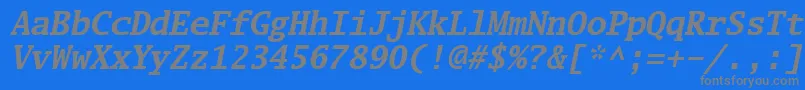 Luximbi-fontti – harmaat kirjasimet sinisellä taustalla