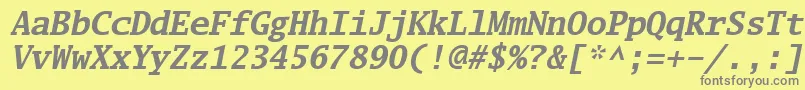 Luximbi-fontti – harmaat kirjasimet keltaisella taustalla