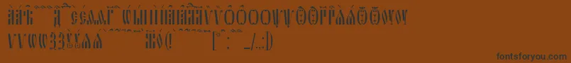 フォントSlavjanicKucs – 黒い文字が茶色の背景にあります