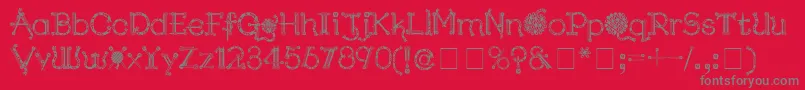 Fonte KingthingsNeedles – fontes cinzas em um fundo vermelho