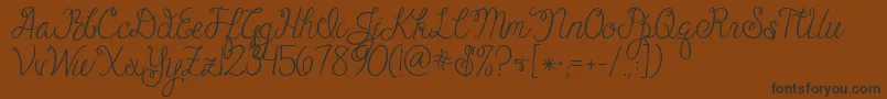 Jandacheerfulscript-Schriftart – Schwarze Schriften auf braunem Hintergrund