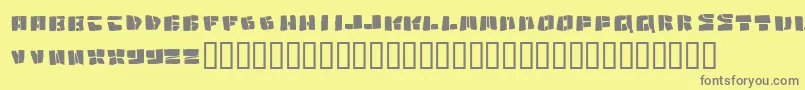 Copycut-fontti – harmaat kirjasimet keltaisella taustalla