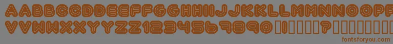 フォントAutomania – 茶色の文字が灰色の背景にあります。