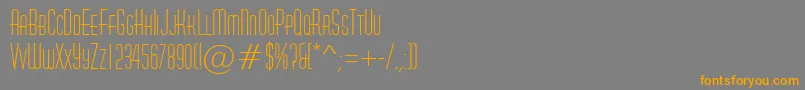 フォントAHuxleycaps – オレンジの文字は灰色の背景にあります。