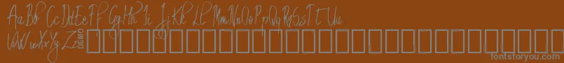 Шрифт EmrytDemo – серые шрифты на коричневом фоне