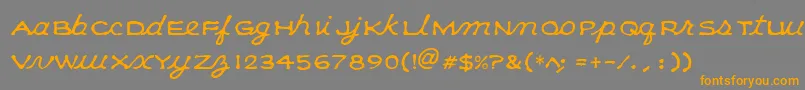 フォントKleeCapscript – オレンジの文字は灰色の背景にあります。