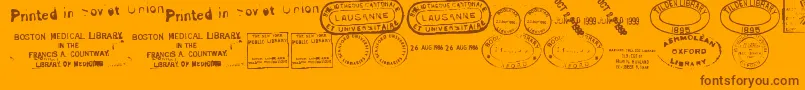 OldSealsTfb-Schriftart – Braune Schriften auf orangefarbenem Hintergrund