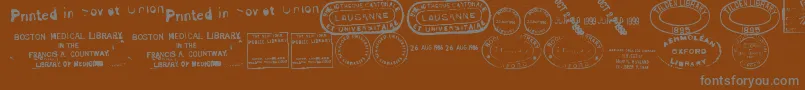 OldSealsTfb-Schriftart – Graue Schriften auf braunem Hintergrund