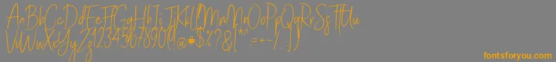フォントStayClassySldt – オレンジの文字は灰色の背景にあります。