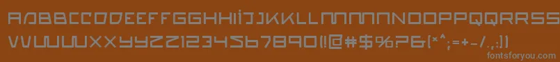 QuasitronBold-fontti – harmaat kirjasimet ruskealla taustalla