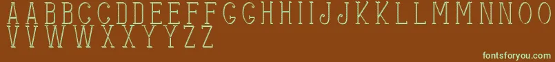 フォントStitchesshadow – 緑色の文字が茶色の背景にあります。