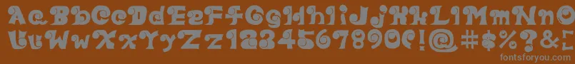 Eyefont-fontti – harmaat kirjasimet ruskealla taustalla
