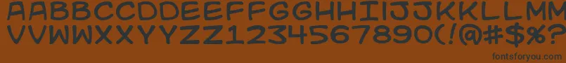 Kidkosmic Font – Black Fonts on Brown Background