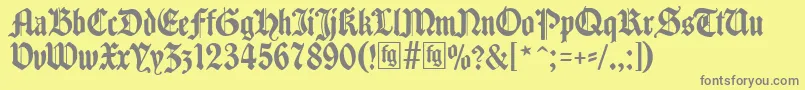 フォントTraditio – 黄色の背景に灰色の文字