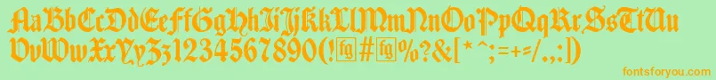 フォントTraditio – オレンジの文字が緑の背景にあります。