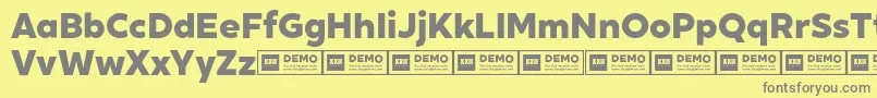 XxiigeomdemoHeavy-fontti – harmaat kirjasimet keltaisella taustalla