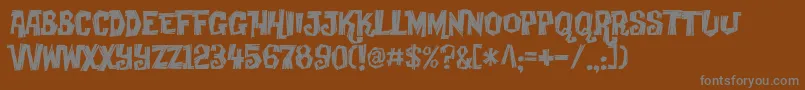 Creaky-Schriftart – Graue Schriften auf braunem Hintergrund