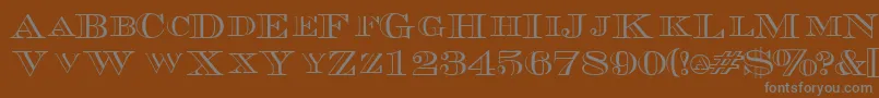 TriboutlinescapssskRegular Font – Gray Fonts on Brown Background