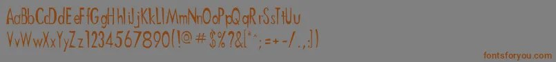 フォントDitnees – 茶色の文字が灰色の背景にあります。