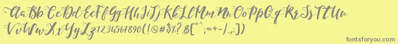 フォントMonicaScript – 黄色の背景に灰色の文字