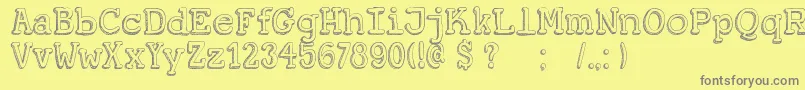 DkKoerier-fontti – harmaat kirjasimet keltaisella taustalla