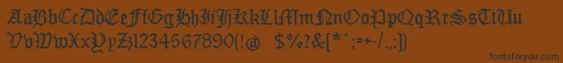 フォントMonamourfraktur2 – 黒い文字が茶色の背景にあります