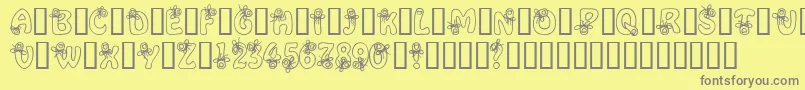 AlphaRemember-fontti – harmaat kirjasimet keltaisella taustalla